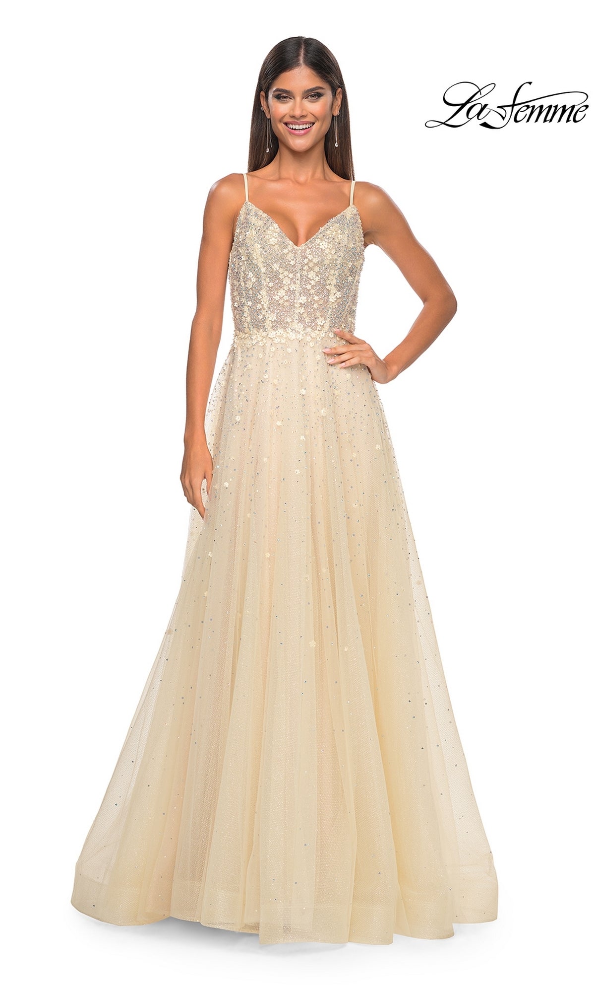 A woman wears the La Femme Embellished Long A-Line Prom Dress 32215, featuring a sleeveless, floor-length light gold design with a fitted sequin bodice and tulle skirt. The La Femme logo is in the top right corner.